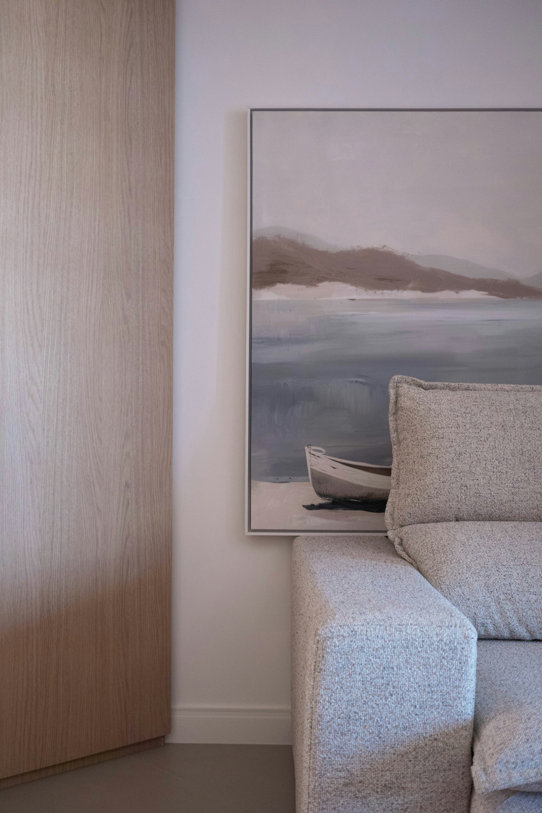 Contemporary painting placed above a sofa in a refined living room